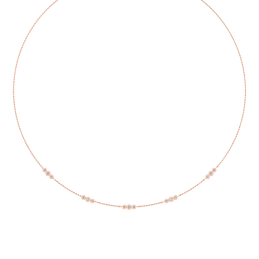 A delicate rose gold chain necklace with small, spaced clusters of clear round-cut stones, displayed on a clean white background.