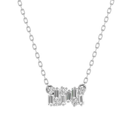 A silver-tone necklace with a delicate chain and a central cluster of clear gemstones, including round brilliant-cut and baguette-cut stones, set against a plain white background.