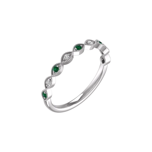 A delicate ring featuring a central emerald gemstone with surrounding diamonds, set in a silver band.
